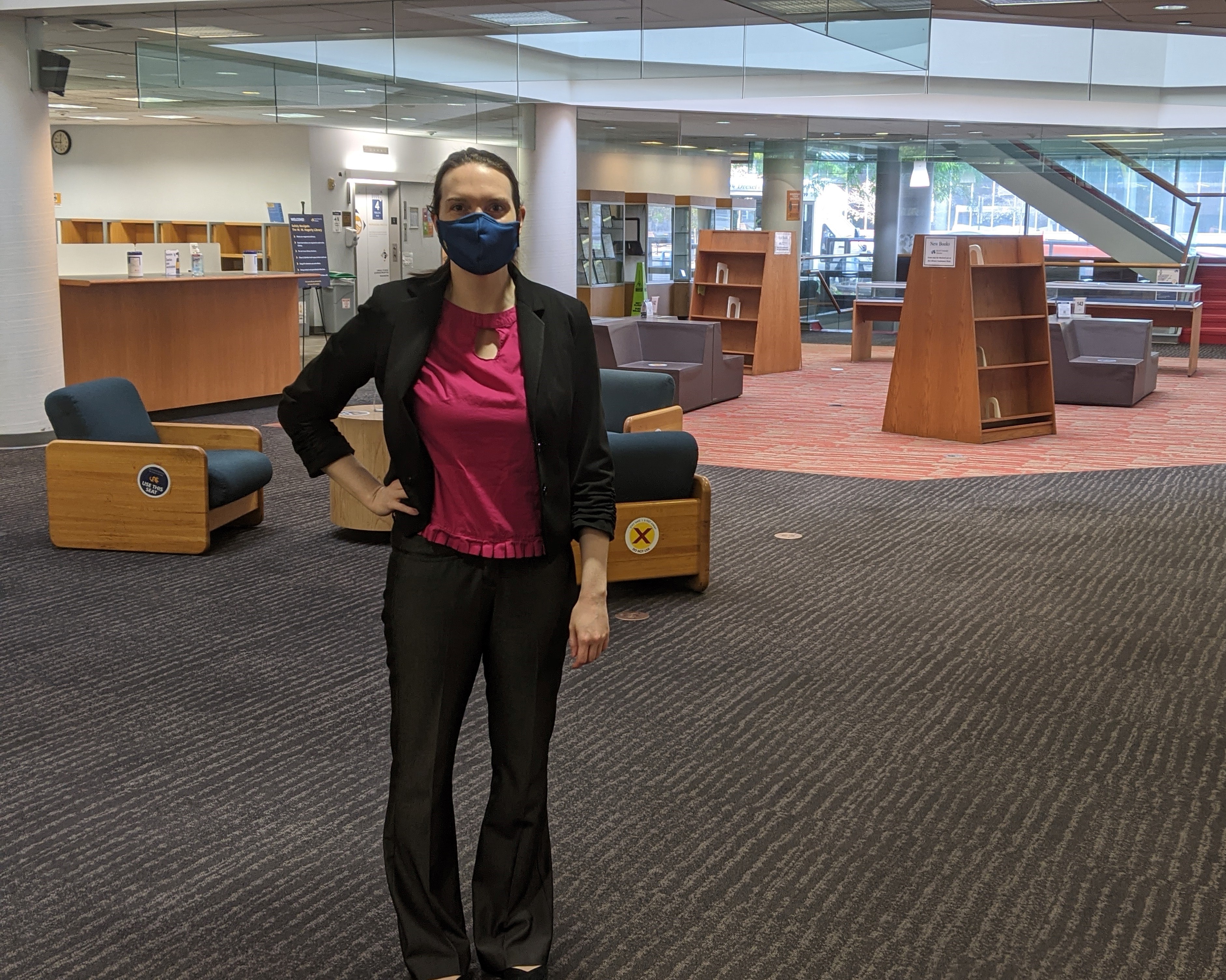 A woman stands in the lobby of the W. W. Hagerty Library